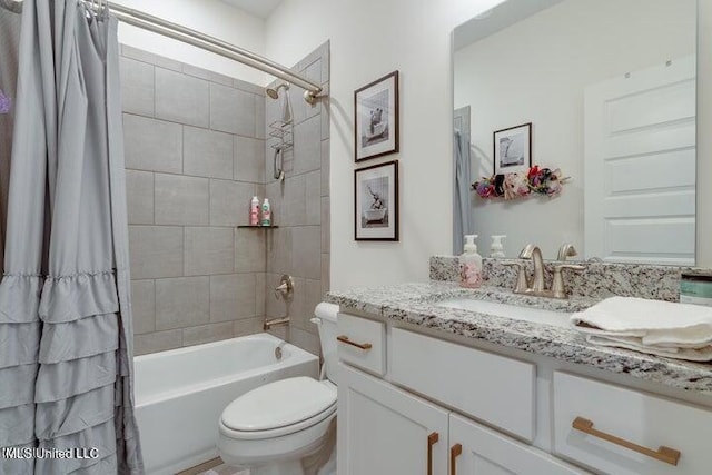 bathroom featuring toilet, vanity, and shower / bath combination with curtain