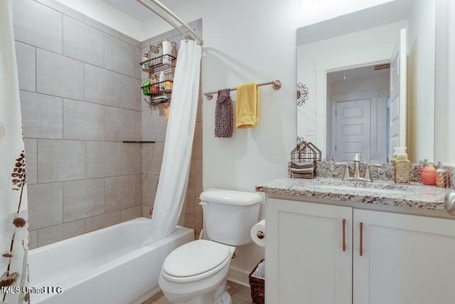 full bathroom featuring shower / bath combo with shower curtain, toilet, and vanity