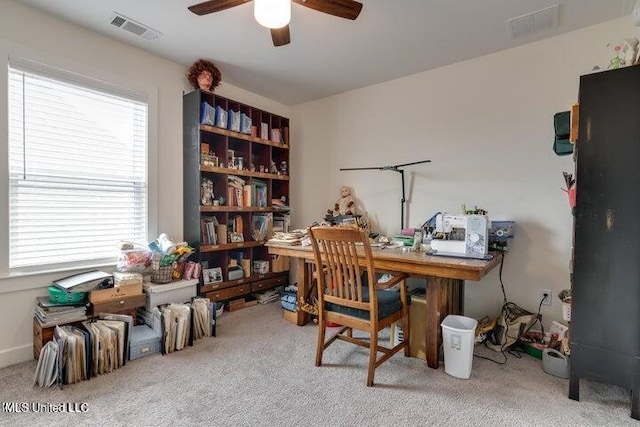 carpeted office space featuring a ceiling fan and visible vents