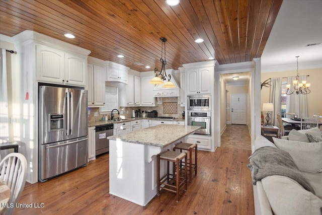 136 Mullherrin Dr, Madison, MS 39110 - kitchen with white cabinets, an inviting chandelier, a sink, open floor plan, and stainless steel appliances