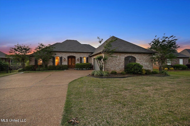 136 Mullherrin Dr, Madison, MS 39110 - french country home with a lawn, a garage, driveway, and brick siding