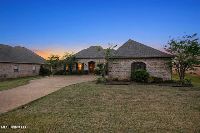 136 Mullherrin Dr, Madison, MS 39110 - french country style house with brick siding, driveway, and a front lawn