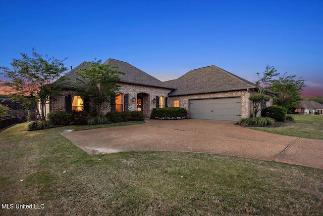136 Mullherrin Dr, Madison, MS 39110 - french provincial home featuring a yard, brick siding, driveway, and an attached garage