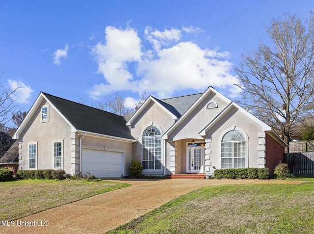 single story home featuring driveway, a garage, stucco siding, fence, and a front yard