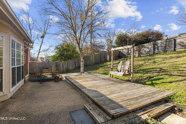 wooden deck with a patio area, a fenced backyard, and a yard