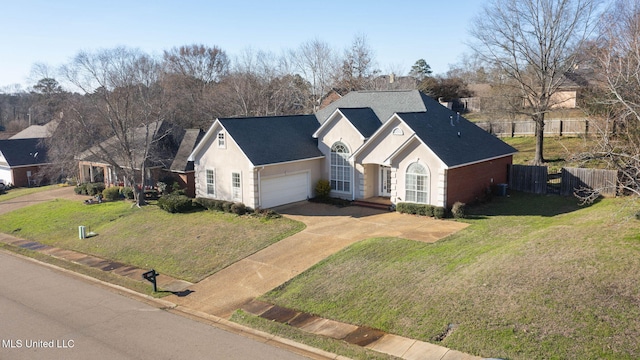 view of front of home featuring a garage, fence, concrete driveway, stucco siding, and a front lawn