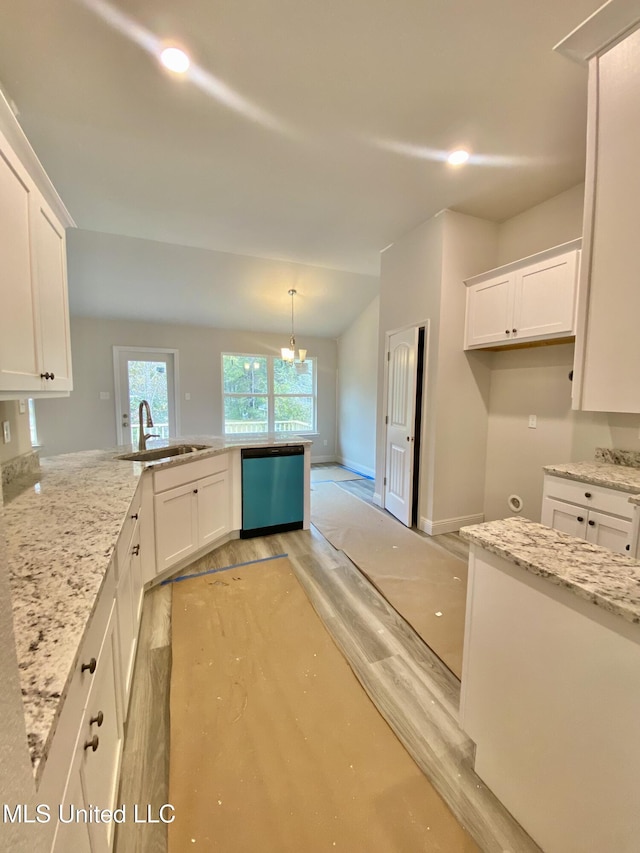 kitchen with white cabinets, light stone counters, stainless steel dishwasher, and sink