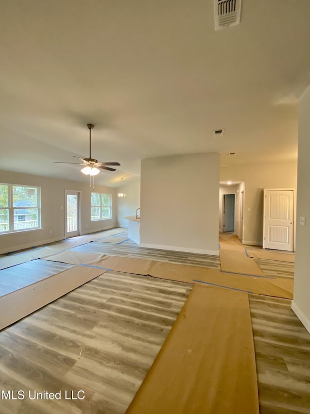 unfurnished room featuring light hardwood / wood-style floors, ceiling fan, and a healthy amount of sunlight