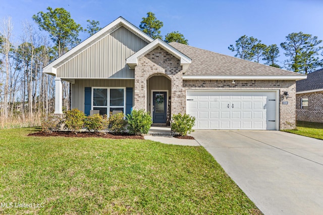 view of front of home with driveway, an attached garage, a shingled roof, a front lawn, and brick siding