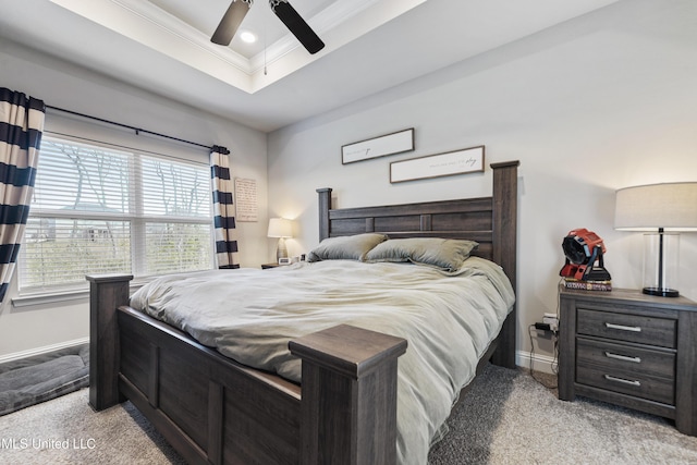 bedroom featuring baseboards, a raised ceiling, light carpet, and crown molding