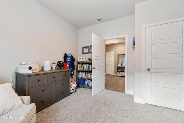 sitting room with visible vents, baseboards, and carpet flooring