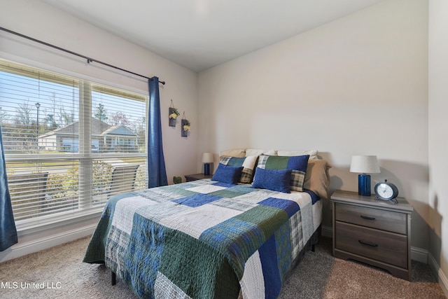 carpeted bedroom with baseboards