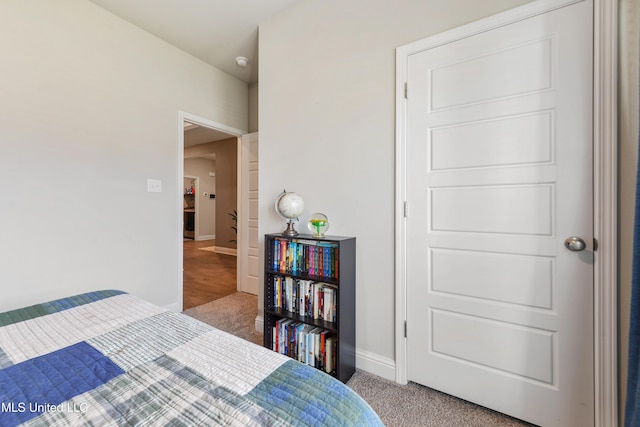 bedroom with baseboards and carpet