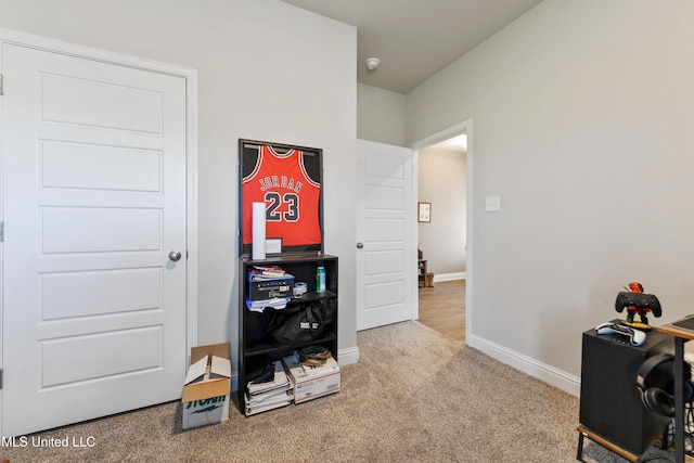 carpeted office space featuring baseboards