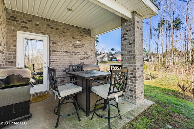 view of patio / terrace featuring outdoor dining area and a grill