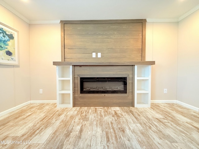 unfurnished living room featuring ornamental molding, a fireplace, wood finished floors, and baseboards