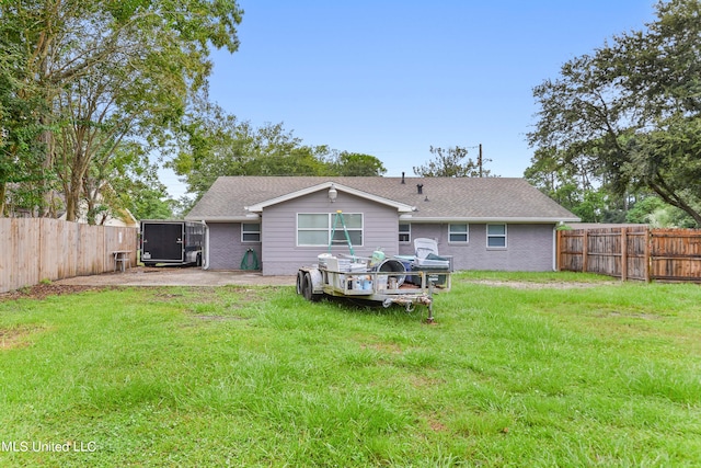 back of property featuring a yard