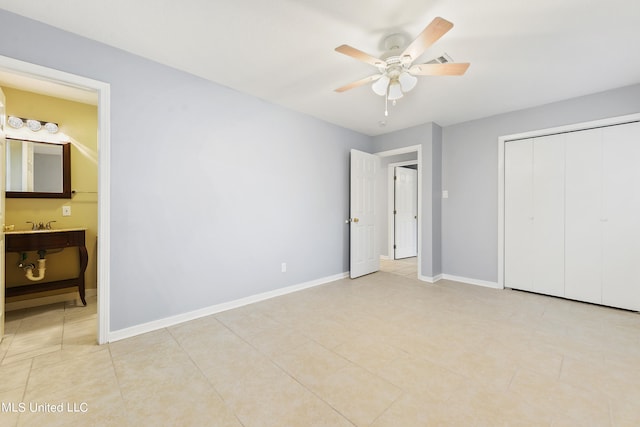 unfurnished bedroom with connected bathroom, ceiling fan, a closet, and light tile patterned floors