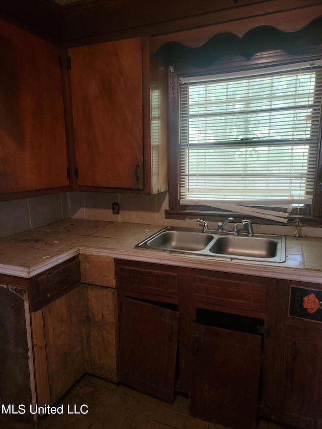 kitchen featuring tile countertops, sink, and tile patterned floors