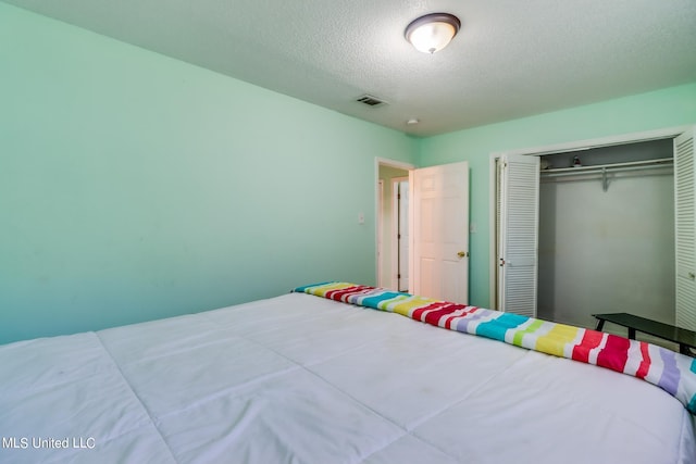 bedroom featuring a closet and a textured ceiling