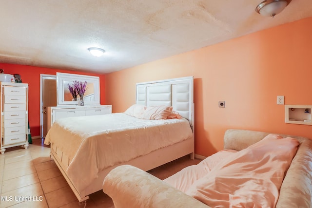 bedroom featuring tile patterned floors and a textured ceiling