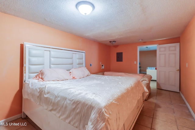 tiled bedroom featuring electric panel, a textured ceiling, and a closet