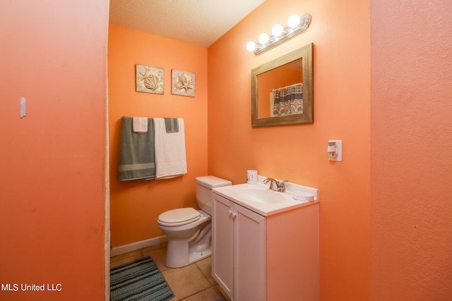 bathroom featuring vanity, toilet, tile patterned floors, and a textured ceiling