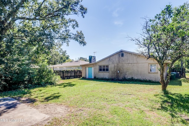 back of house featuring a yard