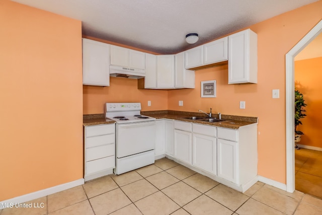 kitchen featuring electric stove, sink, light tile patterned floors, and white cabinets