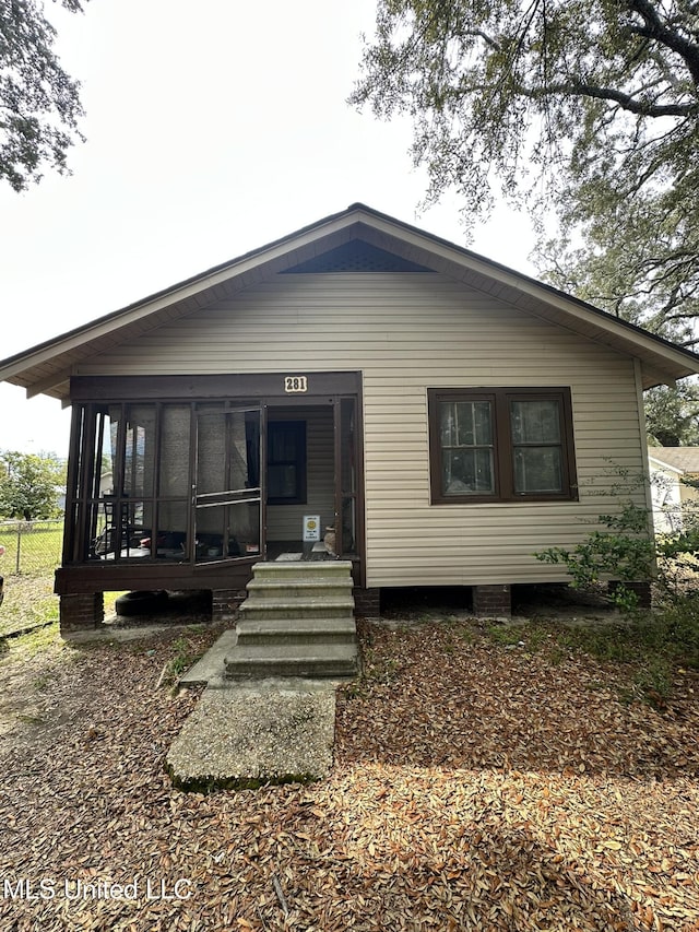 back of property featuring a sunroom