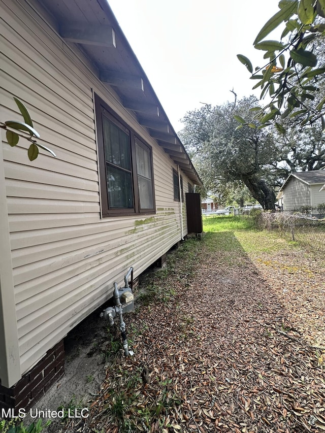 view of side of home with fence
