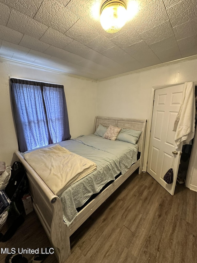 bedroom with dark wood-style floors