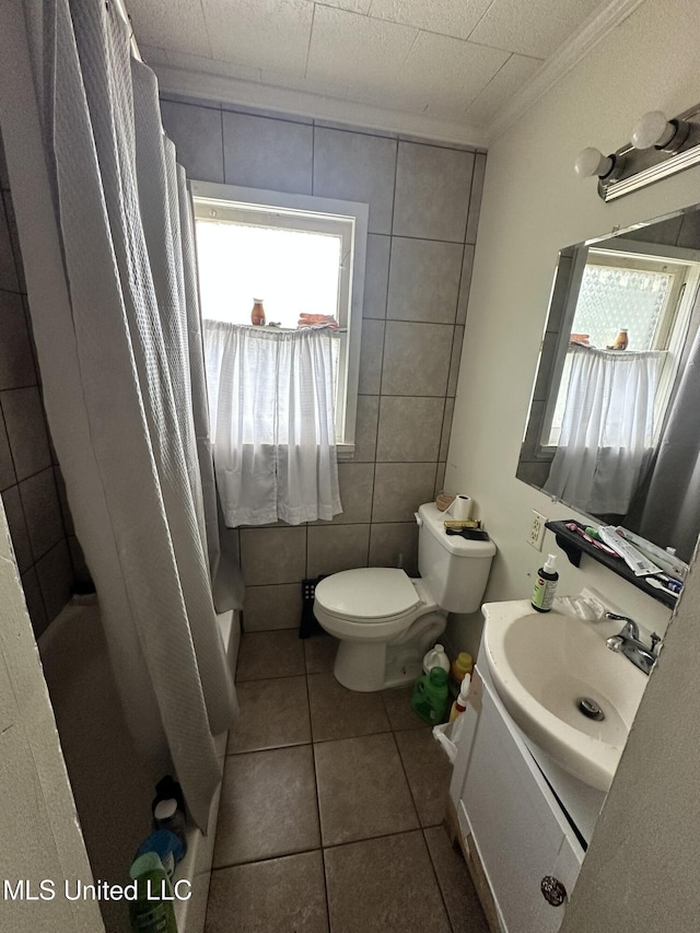 full bathroom featuring a shower with curtain, vanity, crown molding, toilet, and tile patterned floors
