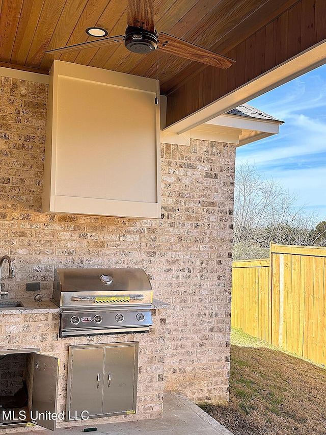 view of patio / terrace with a sink, fence, a ceiling fan, and area for grilling