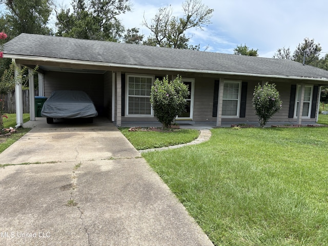 1717 Cherokee St, Pascagoula, MS 39581 - ranch-style home with driveway, a front lawn, a carport, and a shingled roof