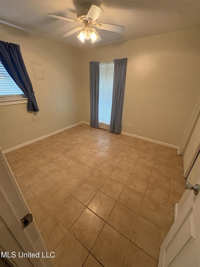 1717 Cherokee St, Pascagoula, MS 39581 - unfurnished room featuring light tile patterned floors, a textured ceiling, and a ceiling fan