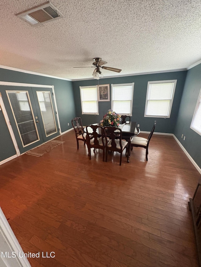 1717 Cherokee St, Pascagoula, MS 39581 - dining area featuring a textured ceiling, crown molding, dark wood-style floors, french doors, and a ceiling fan