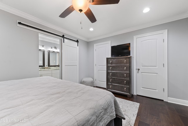 17508 John Cumbest Rd, Moss Point, MS 39562 - bedroom with ornamental molding, recessed lighting, a barn door, dark wood-style flooring, and ensuite bath