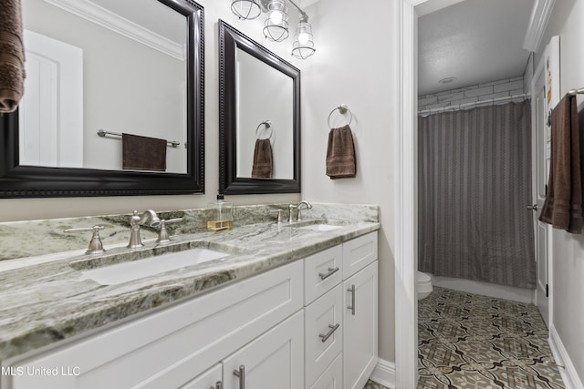 17508 John Cumbest Rd, Moss Point, MS 39562 - bathroom featuring crown molding, double vanity, and toilet