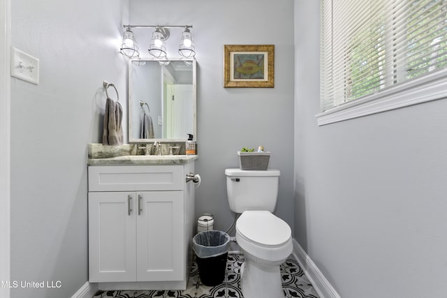 17508 John Cumbest Rd, Moss Point, MS 39562 - half bathroom with baseboards, vanity, and toilet
