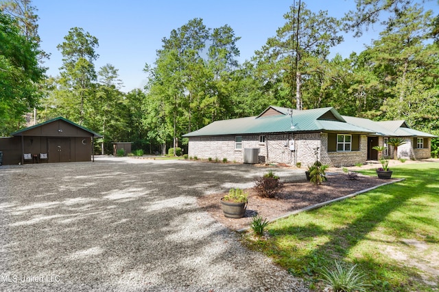 17508 John Cumbest Rd, Moss Point, MS 39562 - view of home's exterior with driveway, metal roof, and central air condition unit