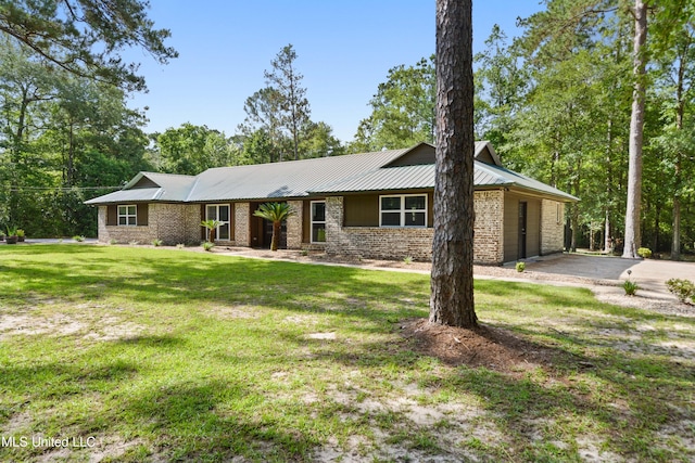 17508 John Cumbest Rd, Moss Point, MS 39562 - view of front facade with a front lawn, metal roof, and brick siding