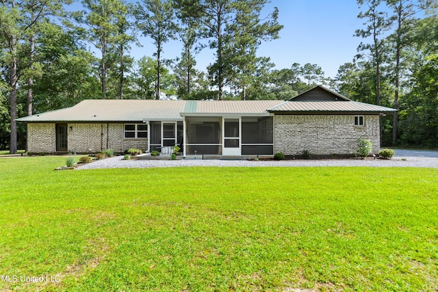 17508 John Cumbest Rd, Moss Point, MS 39562 - ranch-style house with a sunroom, a front lawn, and metal roof