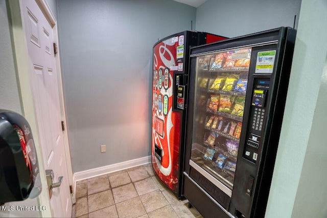 interior space with baseboards and refrigerator
