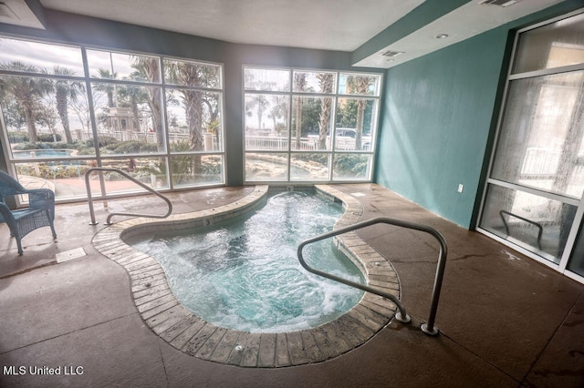 view of swimming pool featuring an indoor hot tub