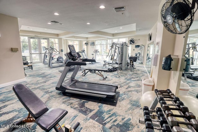 exercise room featuring carpet floors, recessed lighting, a tray ceiling, and visible vents