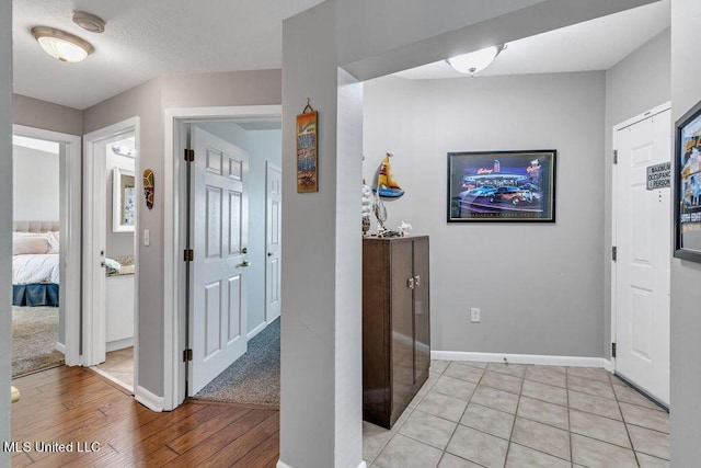 interior space featuring baseboards and light wood-style flooring