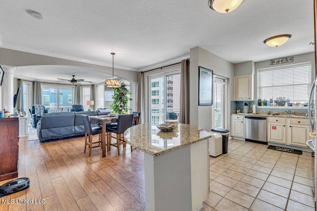 kitchen with ceiling fan, stainless steel dishwasher, light hardwood / wood-style flooring, crown molding, and decorative light fixtures