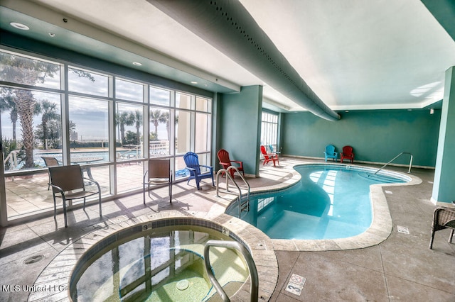 view of swimming pool featuring an indoor hot tub