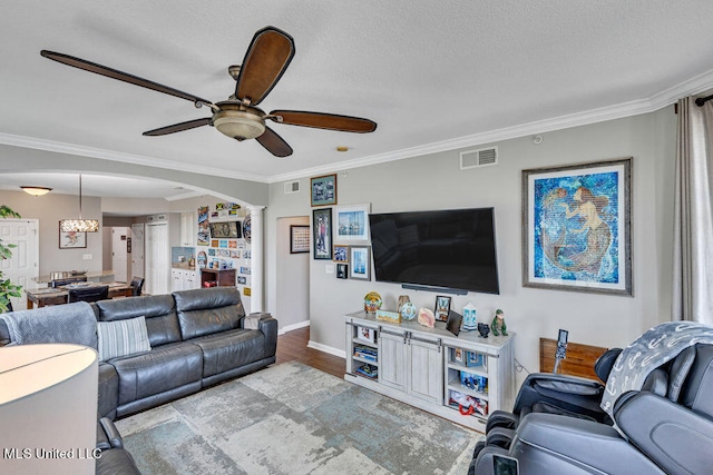 living room with crown molding, light hardwood / wood-style flooring, and ceiling fan